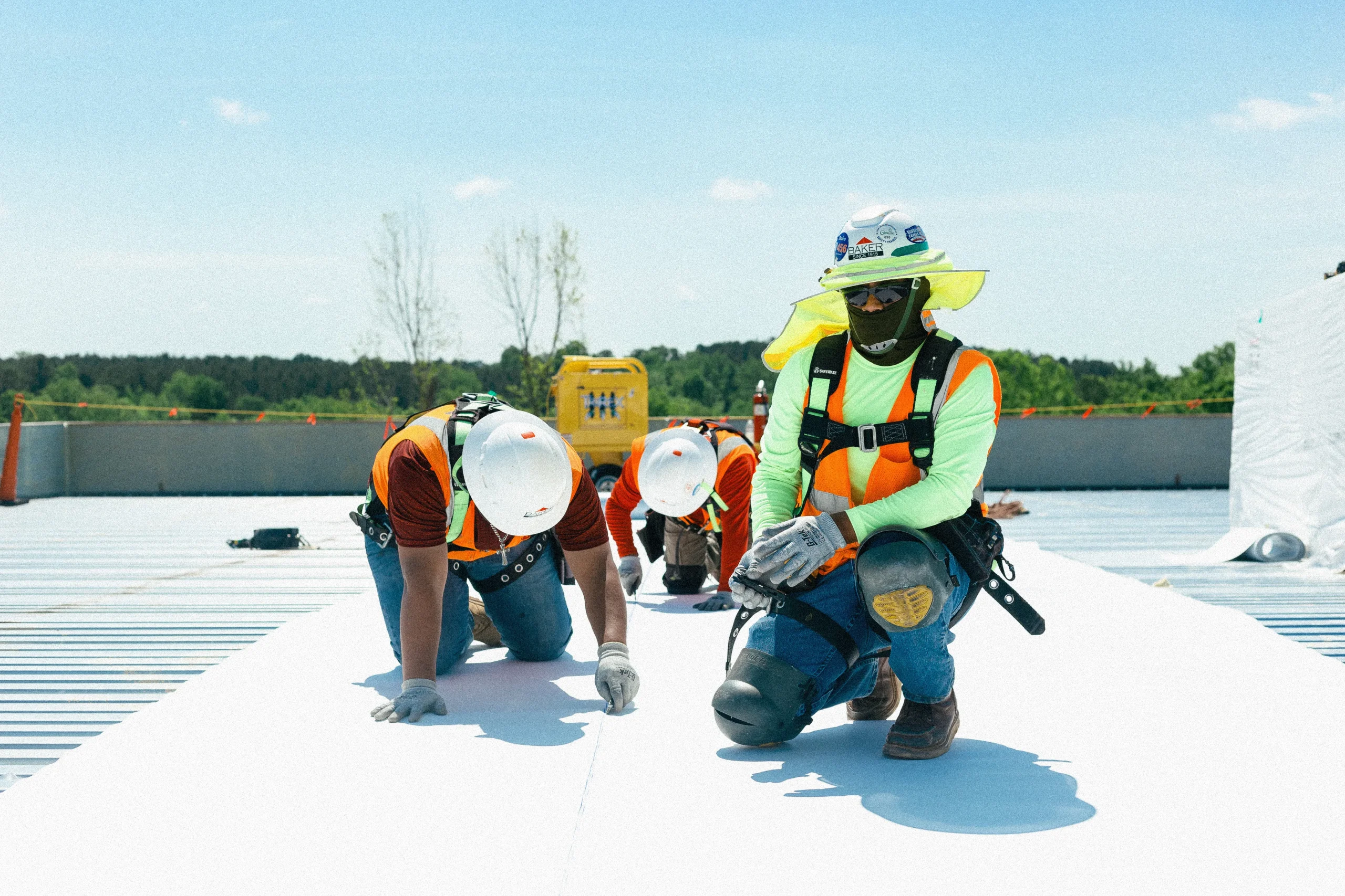 Baker crew installing a single-ply membrane roof