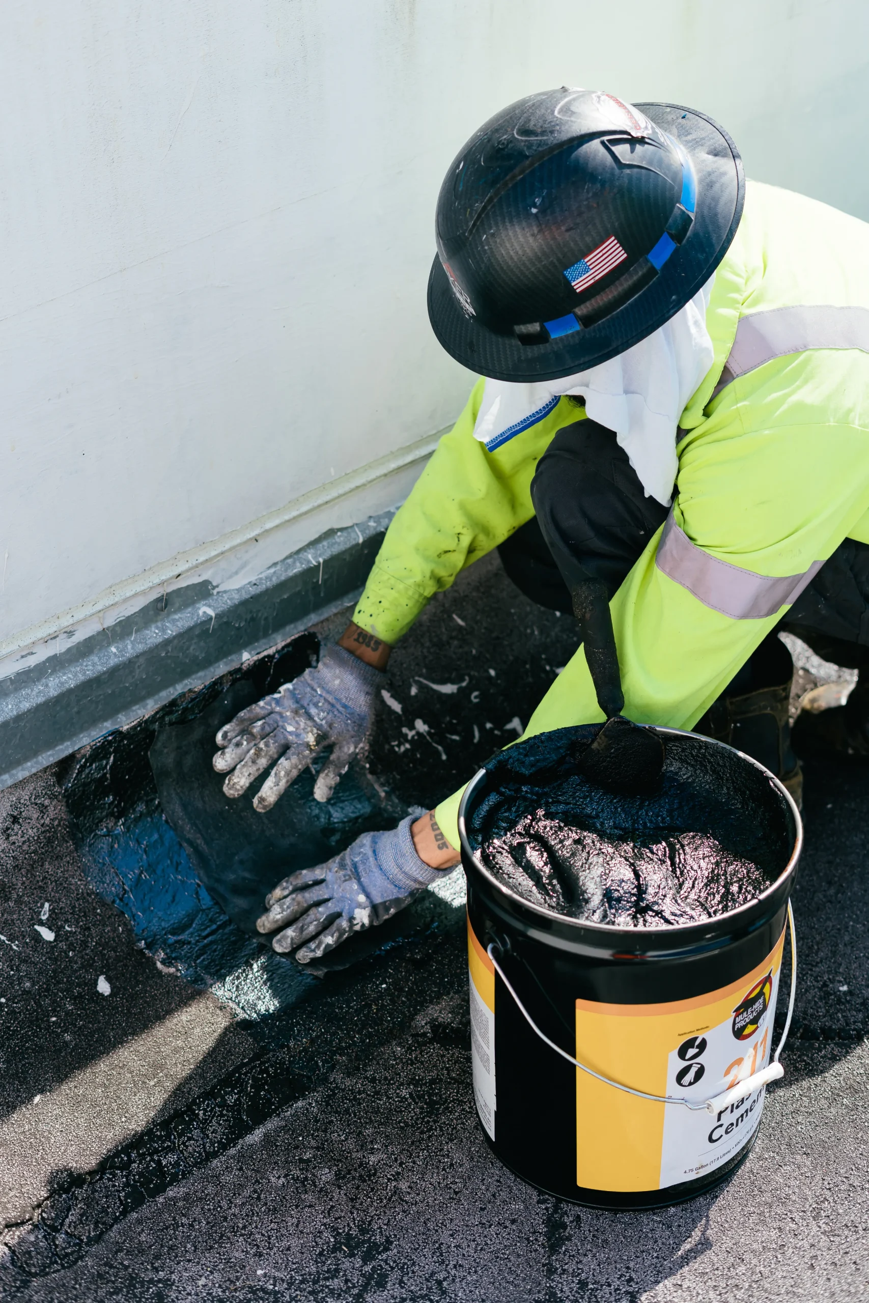 Technician servicing a roof drain