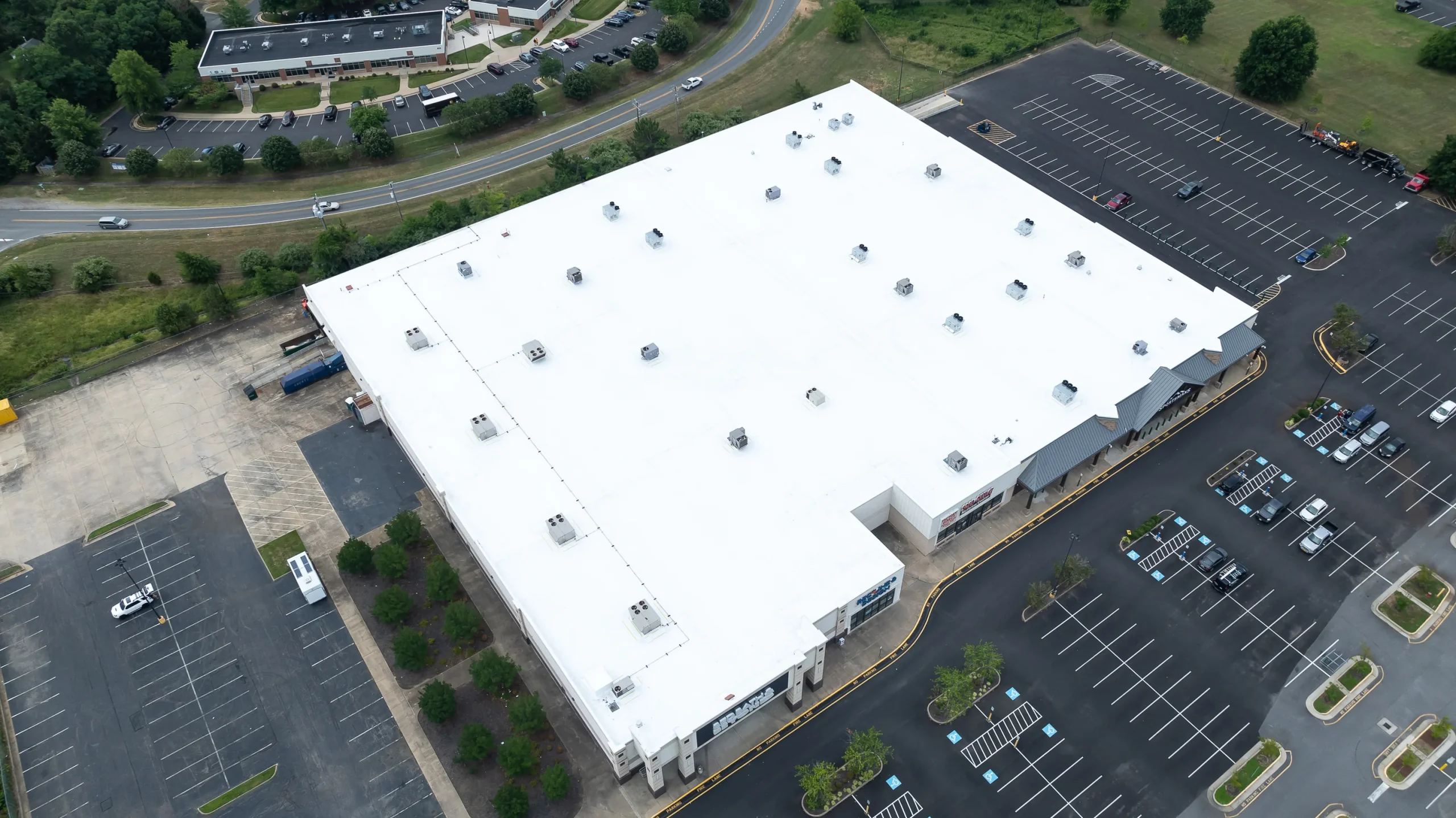 Aerial view of a large low-slope commercial roof after replacement
